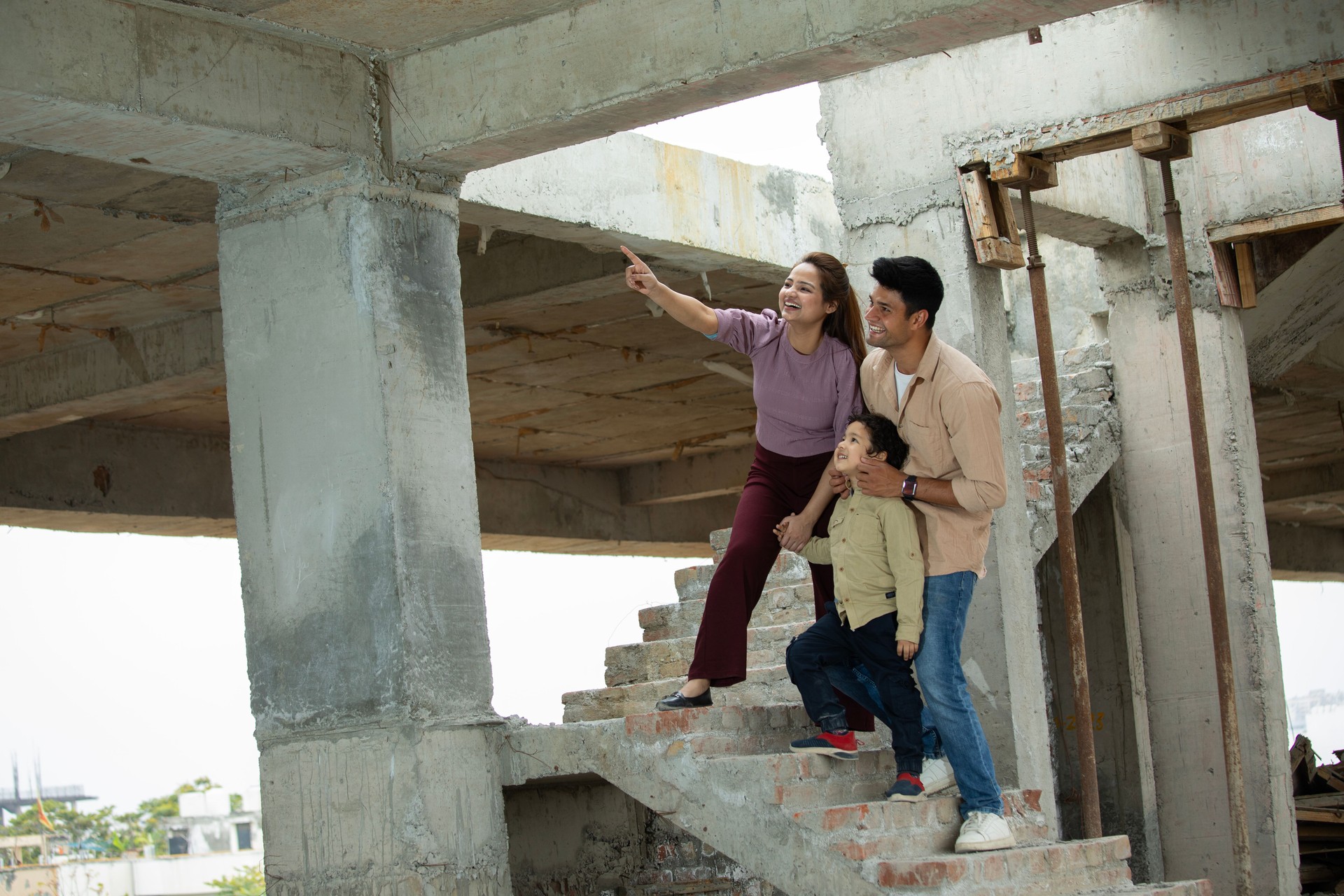 Happy parents with son at site of new house